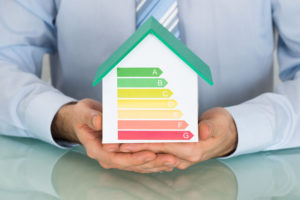 51924951 - businessman showing energy efficiency rate on house model